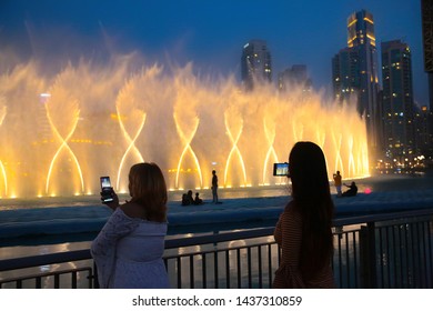 Dubai reopens after ease the lockdown restrictions due to covid-19, restart tourism, Dubai Dancing Fountain Show, Tourist Taking Pictures, Magical view at night life, Luxury travel inspiration