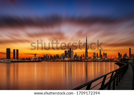 Dubai silhouette Skyline very Dramatic Clouds in Sunset Time with Water and reflection 