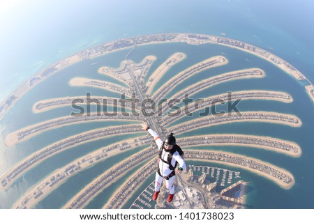 Dubai sky sea. Skydiving travel men stand on Dubai palm in free fall. Skydive Dubai. Skydiving tourism and free fall in summer 