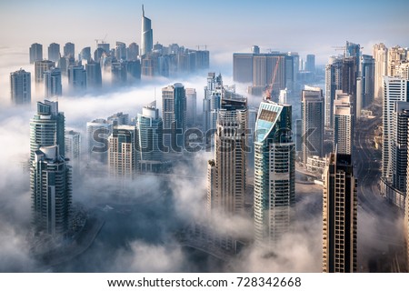 Dubai skyline, an impressive aerial top view of the city in Dubai Marina on a foggy day
