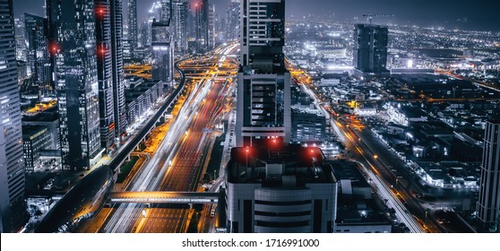 Dubai skyline panorama at night, urban skyscrapers and car traffic, view from above, United Arab Emirates.