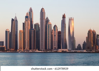 Dubai skyscrapers. Dubai Marina panoramic view, skyline, cityscape. Evening skyline. Dubai sunset. Dubai futuristic skyline. Skyscrapers Princess Tower, Cayan tower, Marina 101.