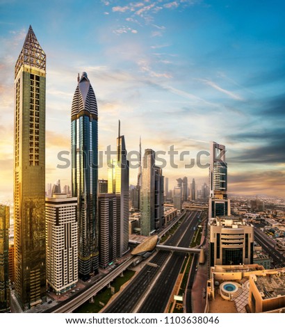 Dubai sunset panoramic view of downtown with skyscrapers. Dubai is super modern city of UAE, cosmopolitan megalopolis.