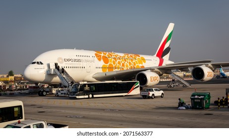 Dubai, UAE, 05.11.2021. Emirates Airbus A380-800 with orange Expo 2020 Dubai livery boarding passengers at Dubai International Airport.