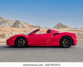 DUBAI  UAE - 08-15-2021: Red Ferrari 488 spider super car in desert near Dubai, fast car new car Ferrari red, luxury exotic car