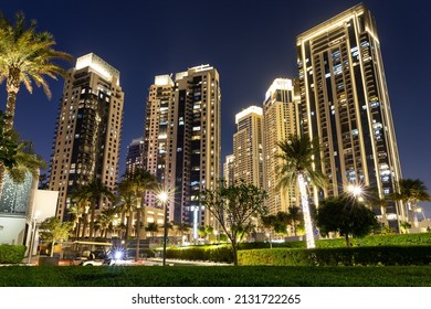 Dubai, UAE, 09.02.22. New Dubai Creek Harbour residence area with Emaar skyscrapers, illuminated at night with palm trees around. 