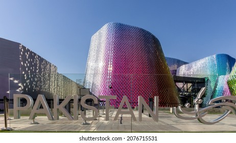 Dubai, UAE, 15.11.2021. Pakistan Pavilion At Expo 2020 Dubai, Colorful Shiny Glass Modern Building With Glass Tiles Facade, PAKISTAN Sign In Front. 