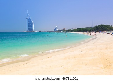DUBAI, UAE - 2 APRIL 2014: People on the Jumeirah Beach in Dubai, UAE. Jumeirah Beach is a white sand beach that is located and named after the Jumeirah district of Dubai.