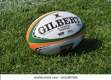 Dubai, UAE - 31 January 2020: An Isolated Gilbert Brand Team Rugby Ball Sits On A Grass Field 