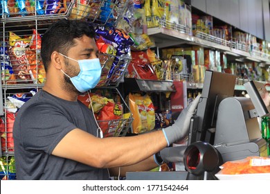 Dubai, UAE: April 19, 2020, vender man standing in his grocery, wearing surgical mask helping to protect community from spreading coronavirus