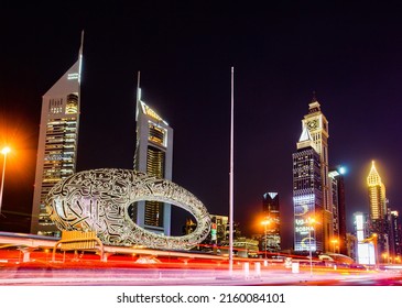 DUBAI, UAE - April 21, 2022: Museum of The Future at night, west side, Sheikh Zayed Road, Jumeirah Emirates Towers.