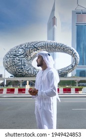 Dubai, UAE, April 4, 2021 - UAE Emirati Man Standing Infront Of Dubai Museum In Traditional Outfit At Sheikh Zayed Road. Young Arab Business Men With Vision And Ambition