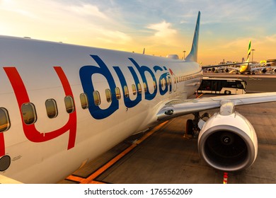 DUBAI, UAE - APRIL 5, 2020: Airplane Flydubai Boeing 737-800 at Dubai International Airport at sunset, Dubai, United Arab Emirates