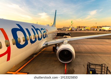 DUBAI, UAE - APRIL 5, 2020: Airplane Flydubai Boeing 737-800 at Dubai International Airport at sunset, Dubai, United Arab Emirates