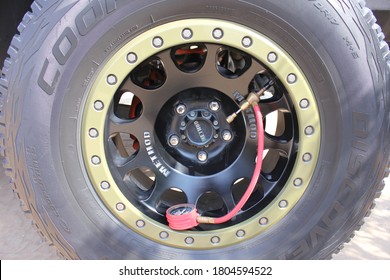 Dubai, UAE - August 28, 2020: Deflator device to rapidly release air from tire valve of a 4x4 vehicle. Driving off-road in Arabian desert sand dunes needs reduced air pressure for greater traction.