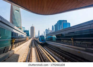 Dubai, UAE, August 7, 2020. Dubai metro train on the railway with skyscrapers on the background. 