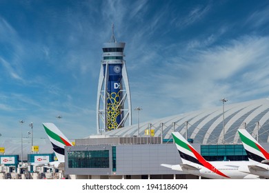 DUBAI, UAE - CIRCA 2021: Emirates Airline Airplanes parked on Dubai Airport, on cloudy sky background. Dubai Airport ATC