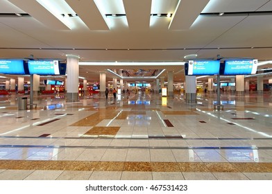 DUBAI, UAE - CIRCA NOVEMBER, 2009: Dubai International Airport DXB Main Entrance Hall Interior View With Information Billboard Floor Reflections Attractive Lightning Detail Panoramic Wide