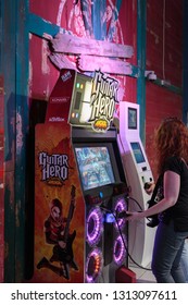 DUBAI - UAE - DECEMBER 26, 2014: A Woman Playing Guitar Hero Arcade At The Dubai Mall, Dubai, United Arab Emirates.