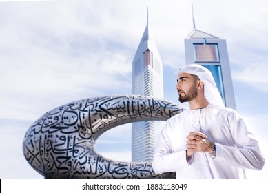 Dubai, UAE, December 26, 2020 - UAE Emirati man standing infront of Dubai Museum in traditional outfit at sheikh zayed road. Young arab business men with vision and ambition