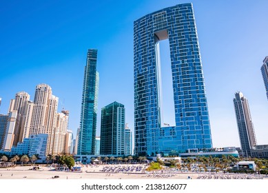 Dubai, UAE. February 10, 2022. Famous Address Beach Resort With Jumeirah Beach Residences Along With Tourists Sunbathing On Sand