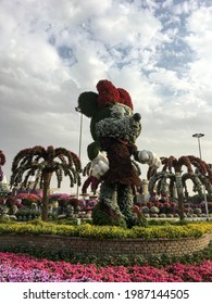 Dubai, UAE - February 11, 2020: Low Angle View Of Huge Mickey Mouse Statue Made Of Green Grass In Dubai Miracle Garden.