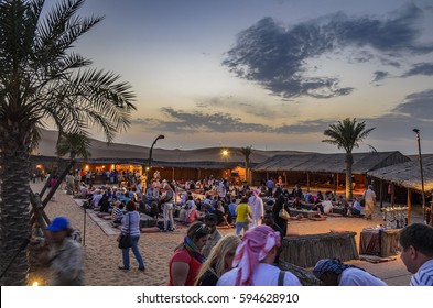 DUBAI, UAE - FEBRUARY 28 2014: Tourists and visitors arrive at the traditional Bedouin camp after experiencing the unique desert safari in Dubai, United Arab Emirates.