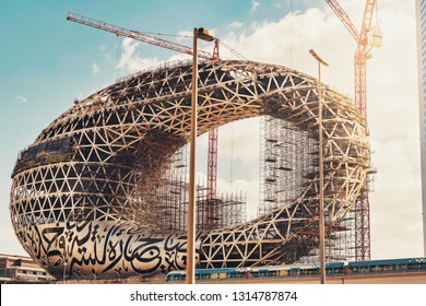 DUBAI, UAE - JAN 20, 2019: The construction of the Museum of the Future one of the world's most advanced buildings. Metro passing by. Opening 2019