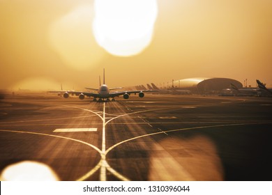 DUBAI, UAE - JAN 25, 2019: Airliners qued up to tax from Dubai airport (DXB) in sandy conditions during early morning.