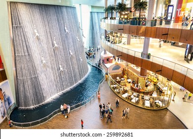 DUBAI, UAE - JANUARY 10, 2015: wide view of artistic waterfalls in Dubai Mall, the world's largest shopping mall, part of the 20 billion dollars Downtown Dubai Complex, and includes around 1,200 shops