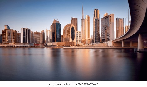 Dubai, UAE, January 12 2023: Dubai Downtown skyline landscape with reflections in Dubai Creek at sunrise, from Dubai Creek Harbour promenade. UAE - Powered by Shutterstock