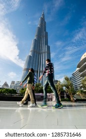 Dubai, UAE - January 14, 2019: An Amazing Worm's Eye View Portrait Image Of The Tallest Building In The World Burj Khalifa Tower On A Sunny Winter Day With People Walking And Shopping In Dubai Mall..