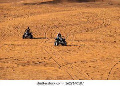 Dubai, UAE - January 2020. People Enjoying Quadbike Or ATV In Dubai Desert