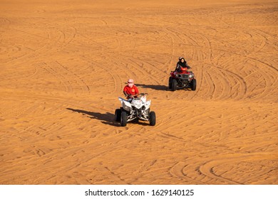 Dubai, UAE - January 2020. People Enjoying Quadbike Or ATV In Dubai Desert