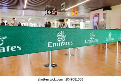 Dubai, UAE, July 2019: green ribbon barrier with the Emirates airlines logo