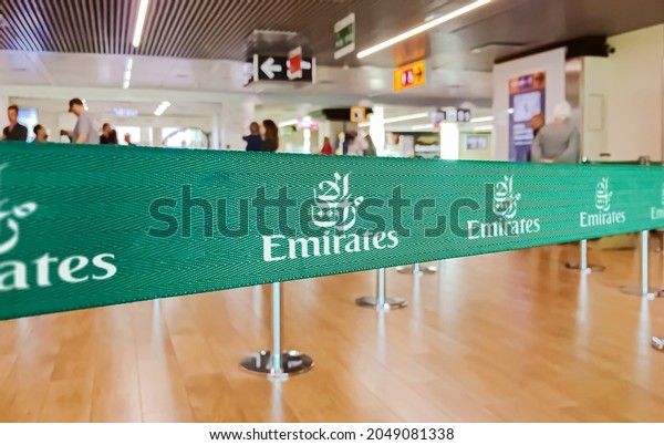 Dubai, UAE, July 2019: green ribbon barrier with the\
Emirates airlines logo