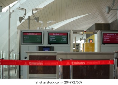 Dubai, UAE - Jun 2010: View Of Departure Gate Reception Desk With Emirates Airlines Logo On Red Queue Retractable Belt Barrier At In Dubai International Airport Terminal. No People.