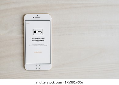 Dubai, UAE - June 10, 2020: Apple Pay Application Set Up On White IPhone 7 Screen, Wooden Table As Background.