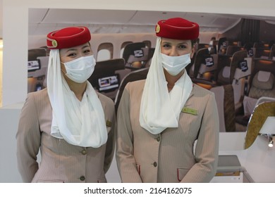 Dubai, UAE - June 5, 2022: Emirates Airline Female Cabin Crew Wearing Face Mask As A Protective Measure Against Covid-19 And Monkeypox Virus Threats.