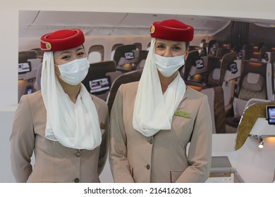 Dubai, UAE - June 5, 2022: Emirates Airline Female Cabin Crew Wearing Face Mask As A Protective Measure Against Covid-19 And Monkeypox Virus Threats.