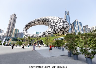 Dubai, UAE - March 28, 2022: Visitors taking photos next to Museum of The Future in Dubai, modern architecture. High quality photo.