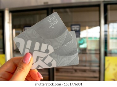 Dubai - UAE - Nobember 6, 2019: A woman holds NOL two metro cards while waiting for metro train in Dubai. Dubai Metro is the world's longest fully automated metro network