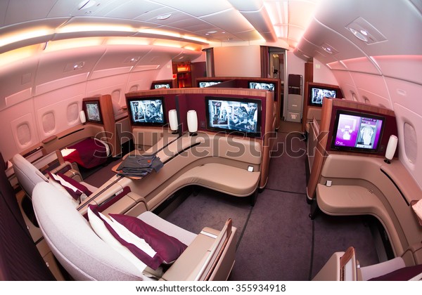 Dubai, UAE - NOVEMBER 10, 2015: Qatar Airways\
Airbus A380 first class luxury seats. Qatar Airways ORYX inflight\
entertainment IFE. Business class travelling. Airline first class\
suit.
