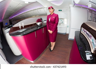 Dubai, UAE - NOVEMBER 11, 2015: Qatar Airways Boeing 787 Cabin Crew Member, Qatar Airways Flight Attendant. Qatar Airways Stewardess Welcomes Aboard 