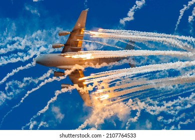 Dubai - UAE, November 13 2021: A Military Cargo Aircraft Dispenses Flares At The Airshow To Show Its Defense Capabilities 