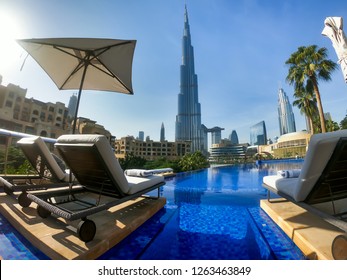 Dubai, UAE - NOVEMBER 15, 2018: Dubai Pool View. Best Dubai View. Futuristic City. Burj Khalifa Tallest Building In The World. Dubai Resort, Holiday, Relax. Hotel Pool. Sunbeds And Infinity Pool. 