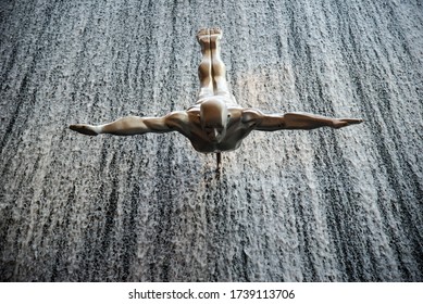 DUBAI, UAE - NOVEMBER 15: A Diver At The Waterfall Inside The Dubai Mall, UAE