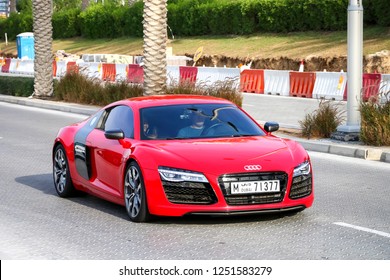 Dubai, UAE - November 16, 2018: Red sportscar Audi R8 in the city street.