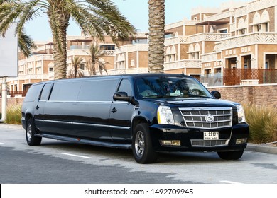 Dubai, UAE - November 18, 2018: Luxury black limousine Cadillac Escalade in the city street.