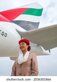 Dubai, UAE - NOVEMBER 21, 2019: Smiling Flight Attendant. Emirates Airline Cabin Crew Member. Emirates Stewardess Standing Near Aircraft.